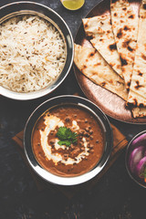 Dal makhani / makhni is a popular dish from India. Made with ingredients like whole black lentil, butter and cream. Served with Naan/roti and rice