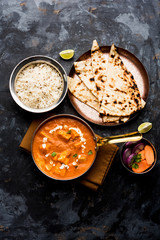 Paneer Butter Masala or Cheese Cottage Curry in serving a bowl or pan, served with or without roti and rice