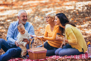 Multl generation family in autumn park having fun