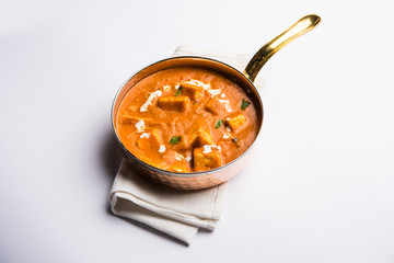 Paneer Butter Masala or Cheese Cottage Curry in serving a bowl or pan, served with or without roti and rice