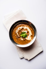 Dal makhani / makhni is a popular dish from India. Made with ingredients like whole black lentil, butter and cream. Served with Naan/roti and rice