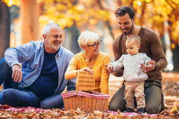 Multl generation family in autumn park having fun