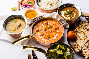 Indian Lunch / Dinner main course food in group includes Paneer Butter Masala, Dal Makhani, Palak Paneer, Roti, Rice etc, Selective focus