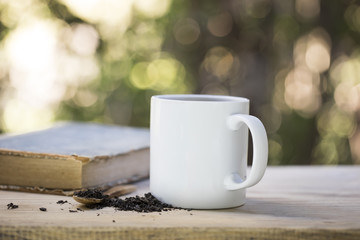 Coffee Cup and Book on The Table in The Morning