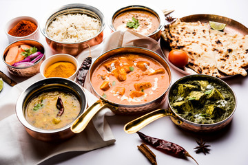 Indian Lunch / Dinner main course food in group includes Paneer Butter Masala, Dal Makhani, Palak Paneer, Roti, Rice etc, Selective focus
