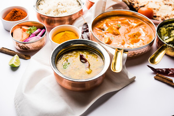 Indian Lunch / Dinner main course food in group includes Paneer Butter Masala, Dal Makhani, Palak Paneer, Roti, Rice etc, Selective focus