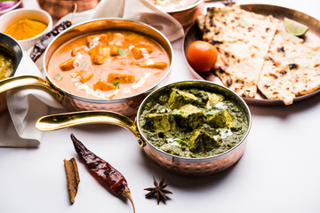 Indian Lunch / Dinner main course food in group includes Paneer Butter Masala, Dal Makhani, Palak Paneer, Roti, Rice etc, Selective focus
