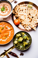 Indian Lunch / Dinner main course food in group includes Paneer Butter Masala, Dal Makhani, Palak Paneer, Roti, Rice etc, Selective focus