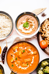 Indian Lunch / Dinner main course food in group includes Paneer Butter Masala, Dal Makhani, Palak Paneer, Roti, Rice etc, Selective focus