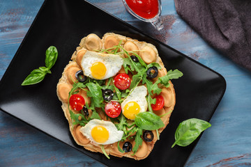 Delicious bubble waffle with fried eggs on plate