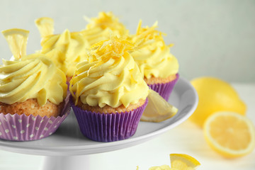 Delicious lemon cupcakes on dessert stand, closeup