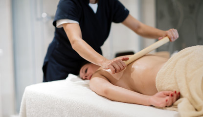 Obraz na płótnie Canvas Masseur treating patient with therapeutic massage