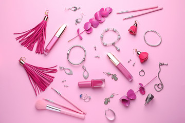 Decorative cosmetics with accessories on color background