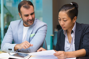 Serious concentrated marketing experts analyzing data while planning project. Thoughtful...
