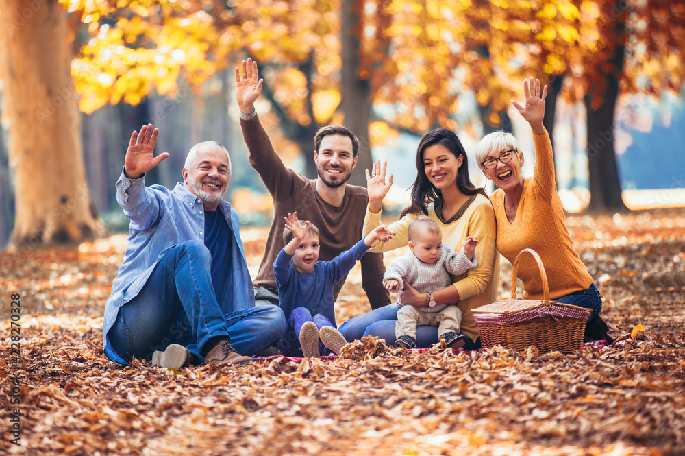 Wall mural Multl generation family in autumn park having fun