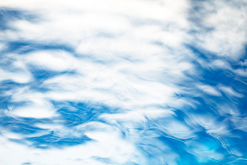 The smooth natural blue water background with bokeh  abstract on the sea or ocean,vintage and soft colored blur.