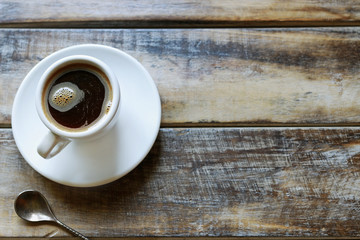 Cup of coffee on brown wooden table