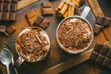 Tasty hot chocolate drink in mugs