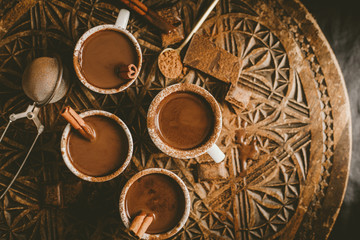 Fototapeta na wymiar Tasty hot chocolate drink in small cups