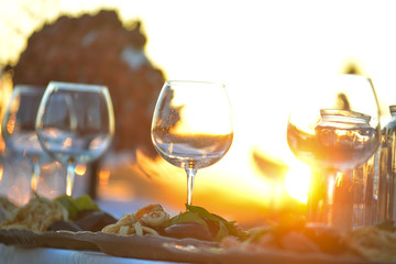 Couple enjoying wine against a beautiful sunset.