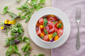 Bowl with delicious watermelon salad on table