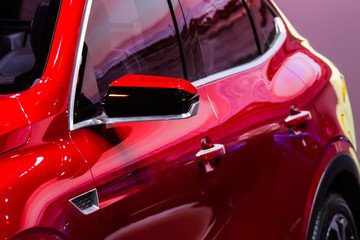 Obraz na płótnie Canvas Closeup high-detailed view on rearview mirror of red car