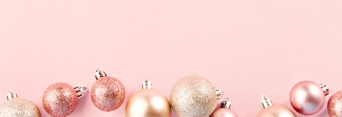 Pink baubles in row on pink