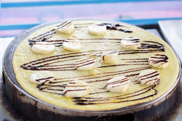 crepe with banana and chocolate on the pan