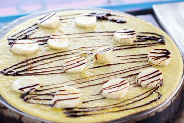 crepe with banana and chocolate on the pan