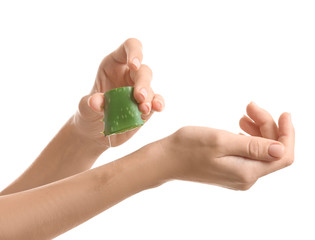 Hands of beautiful young woman with aloe vera on white background