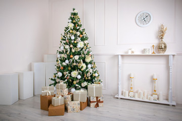 Christmas gift box and baubles. New Year celebration. Decorated Christmas tree with various gifts Holiday scene. Christmas gifts under the tree.
