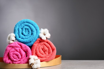 Clean colorful towels on grey table