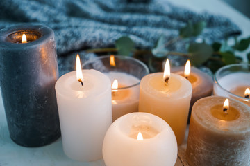 Beautiful burning candles on wooden table