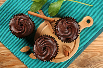 Delicious chocolate cupcakes on wooden table