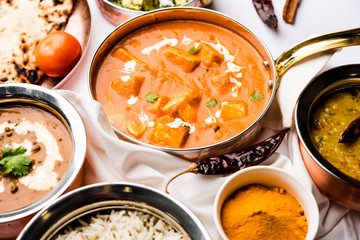 Indian Lunch / Dinner main course food in group includes Paneer Butter Masala, Dal Makhani, Palak Paneer, Roti, Rice etc, Selective focus