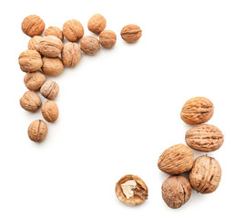 Unpeeled walnuts on white background