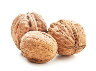 Unpeeled walnuts on white background