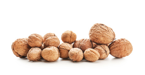 Unpeeled walnuts on white background