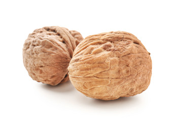 Unpeeled walnuts on white background