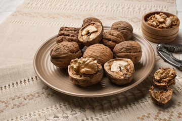 Plate with tasty walnuts on napkin