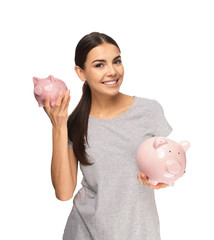 Beautiful young woman with piggy banks on white background