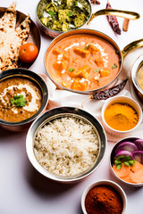 Indian Lunch / Dinner main course food in group includes Paneer Butter Masala, Dal Makhani, Palak Paneer, Roti, Rice etc, Selective focus