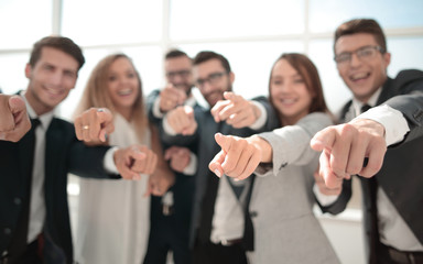 close up. successful business team pointing at you.