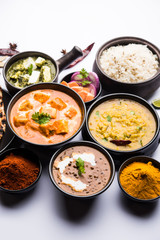 Indian Lunch / Dinner main course food in group includes Paneer Butter Masala, Dal Makhani, Palak Paneer, Roti, Rice etc, Selective focus