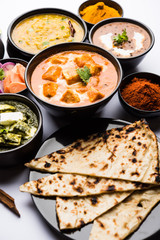 Indian Lunch / Dinner main course food in group includes Paneer Butter Masala, Dal Makhani, Palak Paneer, Roti, Rice etc, Selective focus