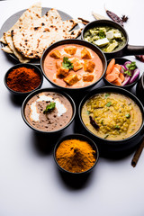 Indian Lunch / Dinner main course food in group includes Paneer Butter Masala, Dal Makhani, Palak Paneer, Roti, Rice etc, Selective focus