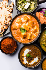 Indian Lunch / Dinner main course food in group includes Paneer Butter Masala, Dal Makhani, Palak Paneer, Roti, Rice etc, Selective focus