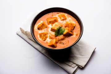Paneer Butter Masala or Cheese Cottage Curry in serving a bowl or pan, served with or without roti and rice