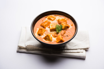Paneer Butter Masala or Cheese Cottage Curry in serving a bowl or pan, served with or without roti and rice