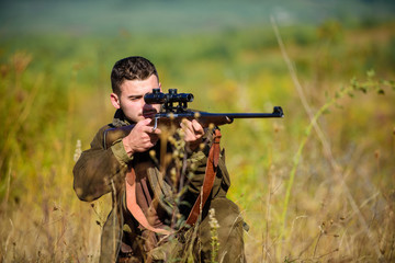 Fototapeta premium Guy hunting nature environment. Hunting weapon gun or rifle. Hunting target. Masculine hobby activity. Experience and practice lends success hunting. Man hunter aiming rifle nature background